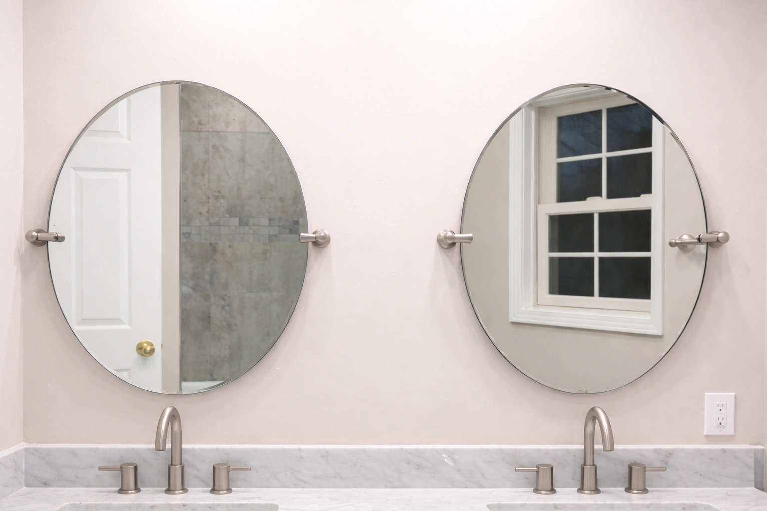 Frameless round mirrors installed above a modern vanity during a bathroom