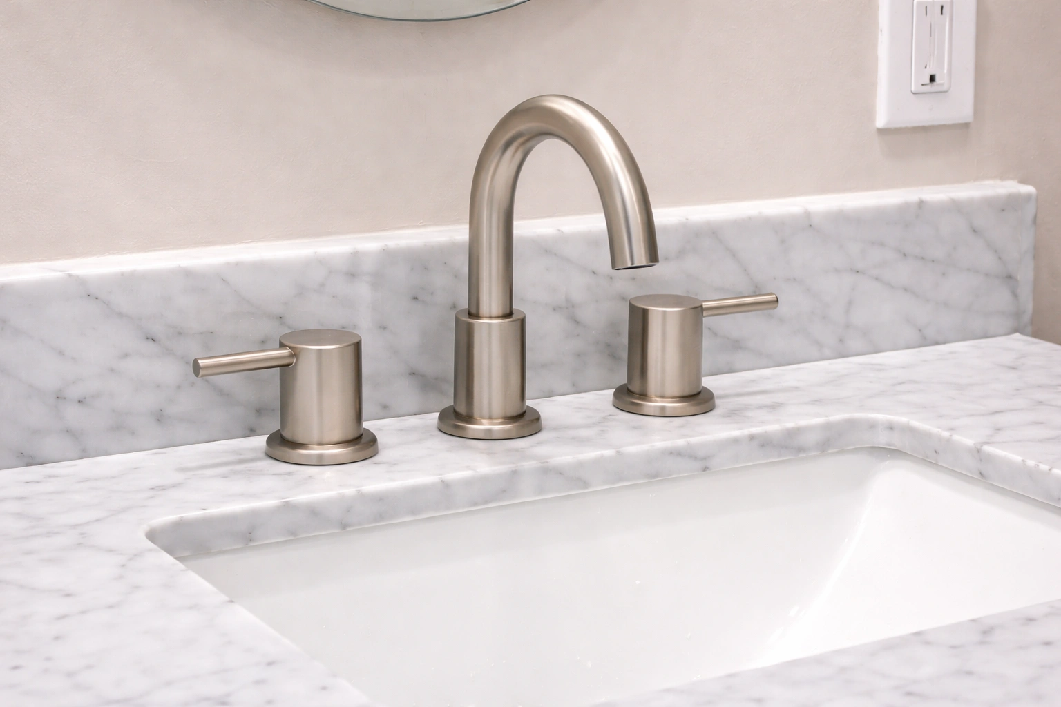 Brushed nickel faucet and undermount sink detail from a bathroom remodeling project in Manalapan Township, NJ.