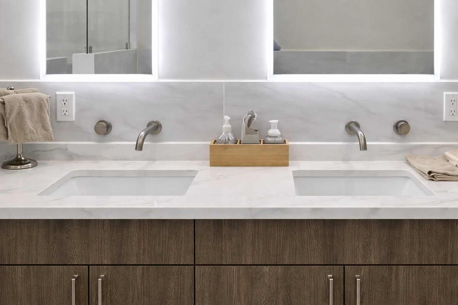 Quartz double-sink vanity with wall-mounted faucets in a contemporary bathroom remodeling project in Freehold, NJ.