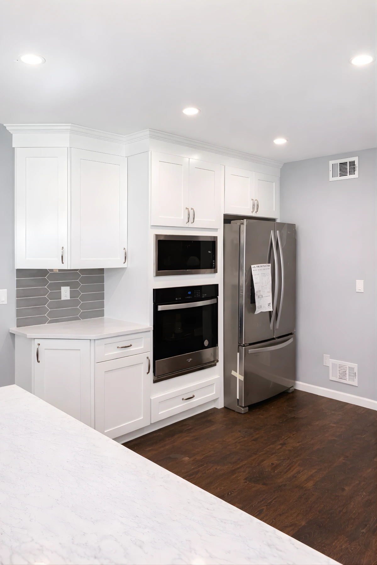 Custom white kitchen cabinetry with built-in stainless steel appliances as part of a kitchen remodeling project in Berkeley Township, NJ.