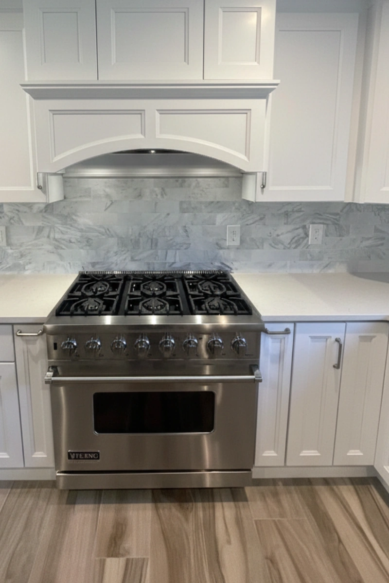 Stainless gas range with white cabinets in a Matawan NJ kitchen remodel