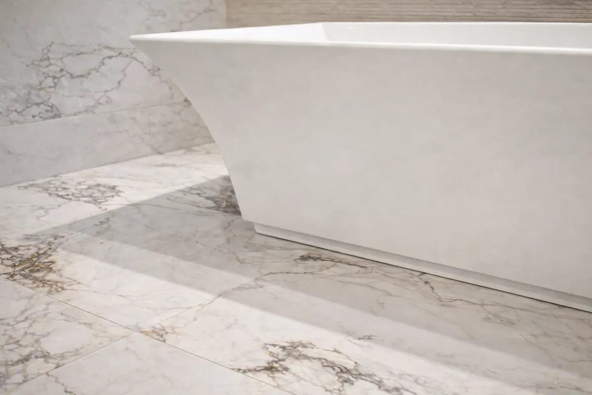 Freestanding tub on marble tile floor installed by Gold Standard Bathrooms